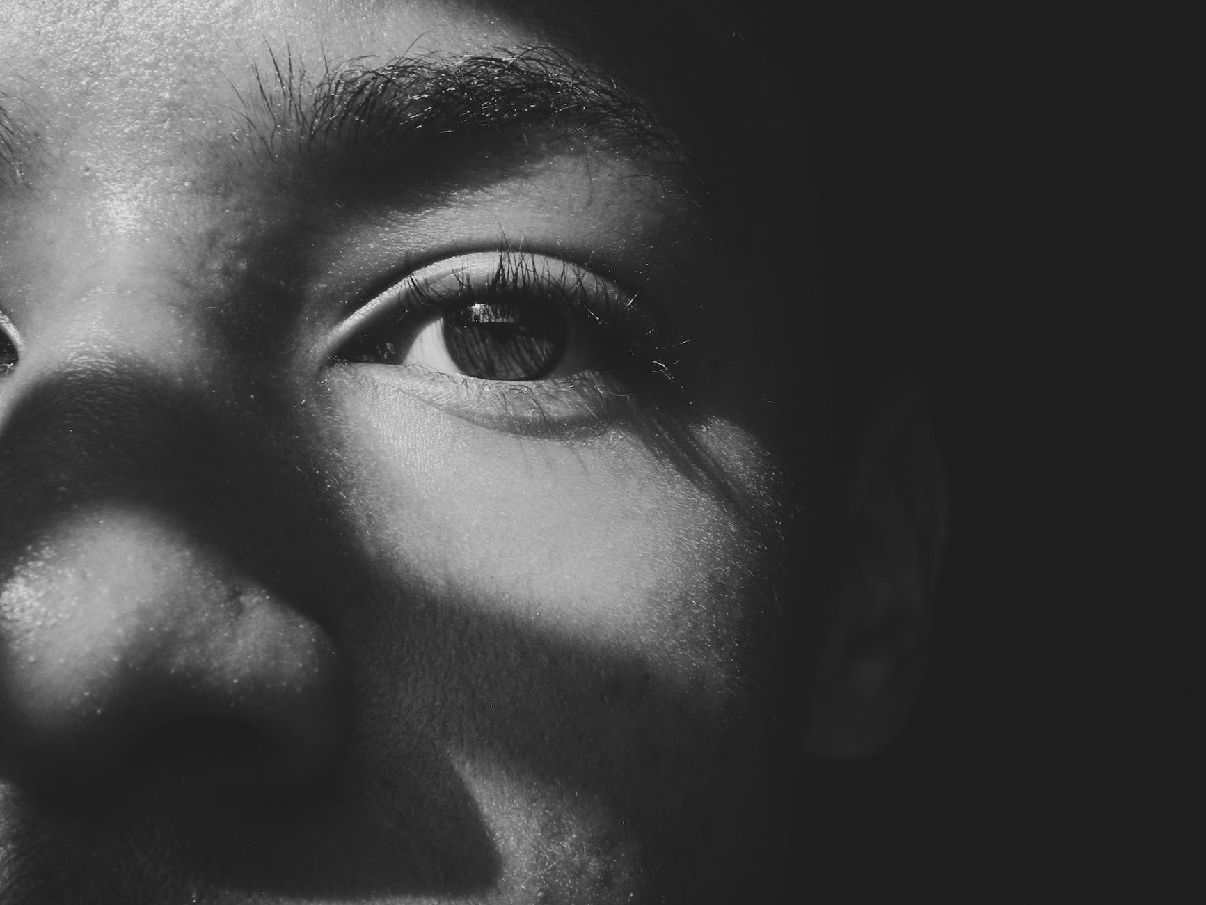 monochrome photo of person s eye